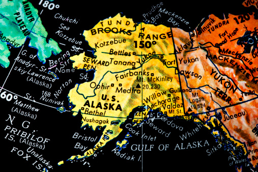 Vintage black ocean globe. Close up of the state of Alaska.