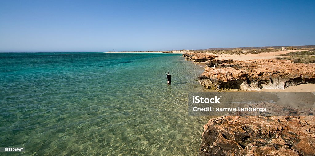 Osprey Bay Fisherman "A lone fisherman at Osprey Bay fishing thd crystal clear waters of Western Australia's famous Ningaloo Reef.  Ningaloo Reef is one of the best diving locations in the southern Hemisphere, famous for its Whale Sharks and Manta Rays." Ningaloo Reef Stock Photo
