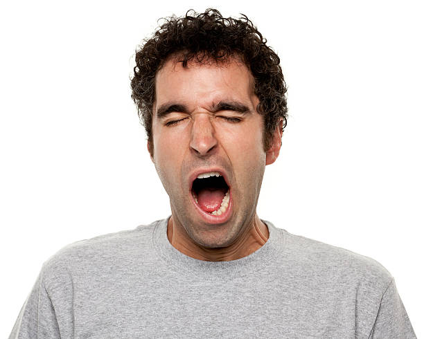 Tired Yawning Man Portrait of a man on a white background. yawning stock pictures, royalty-free photos & images