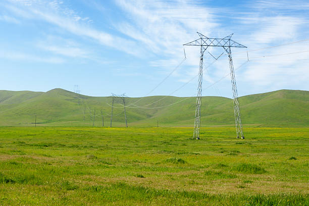 istock Pylons, Power Lines in Grassy Field 183807516