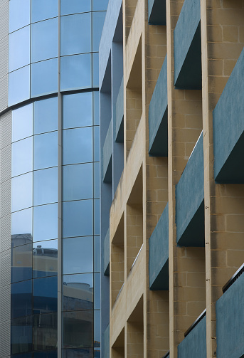 Close-up of a building showcasing contrasting architectural materials and reflective glass
