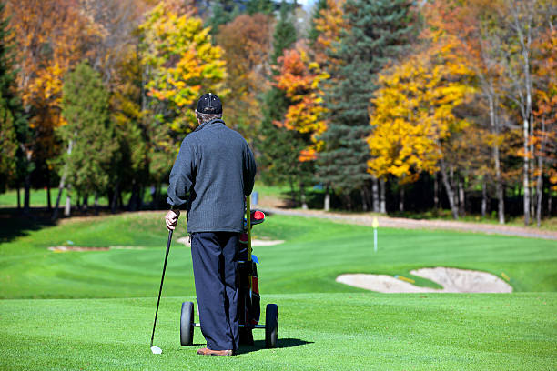 istock Senior Golf Player in Action in Autumn 183807703