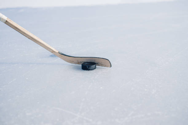 istock Close-up, hockey stick and puck on ice. 1838077936