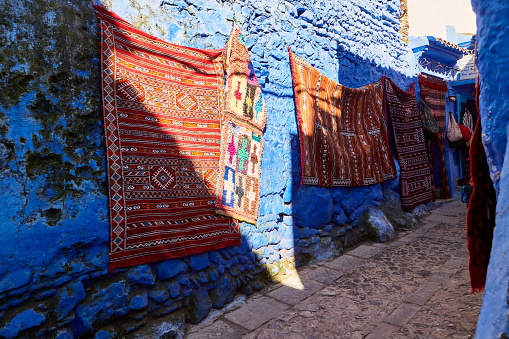 Street with traditional moroccan rugs Chefchaouen, Morocco, Africa.