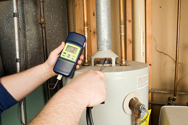 Repairman Checks Carbon Monoxide Level on Gas Water Heater Exhaust  boiler stock pictures, royalty-free photos & images