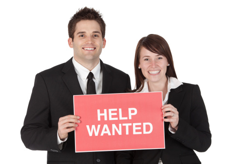 Business couple holding a 'Help Wanted' signhttp://www.twodozendesign.info/i/1.png