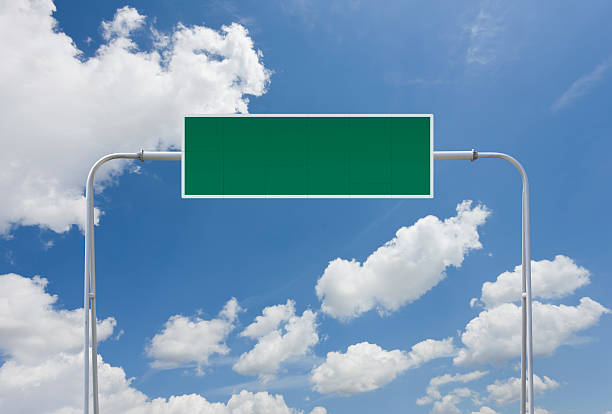 istock Blank green highway sign with clouds 183808517