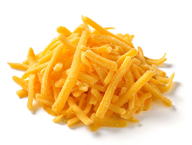 Shredded Cheese on white background "One ounce serving, small pile of shredded cheddar or american cheese on white background with natural shadow.Shot with Nikon D3X" shredded photos stock pictures, royalty-free photos & images