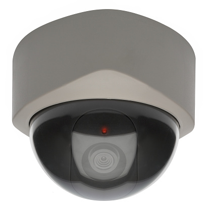 Ceiling mounted security camera with red LED warning indicator.