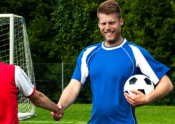 istock Soccer players shake hands as fair play 183809308