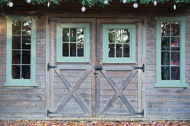 A wooden door with a wooden staircase leading up to it. The door is open