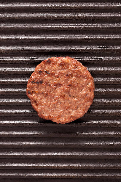 Grilled burger Cooked burger over iron grill grill burgers stock pictures, royalty-free photos & images