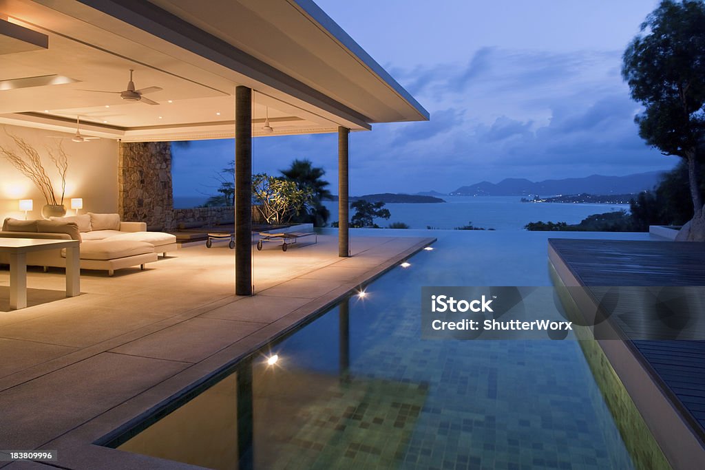 Night view of beautiful villa on island Luxury Island Villa With Infinity Pool At Sunset. Villa Stock Photo
