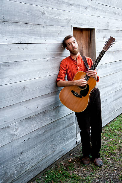 istock Man playing acoustic guitar 183810192