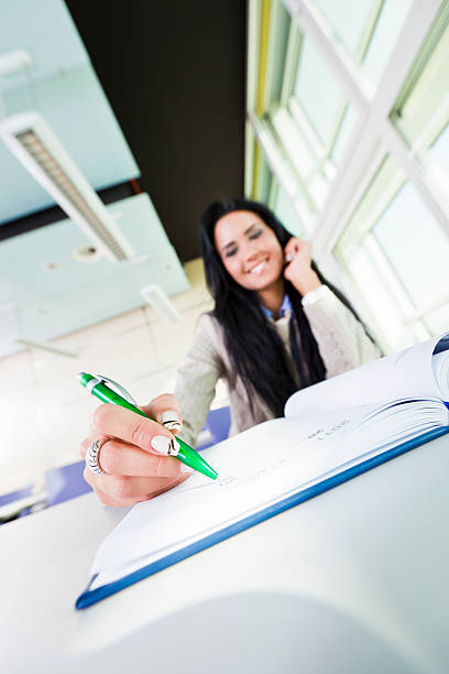 istock Happy businesswoman writing in notebook 183810200