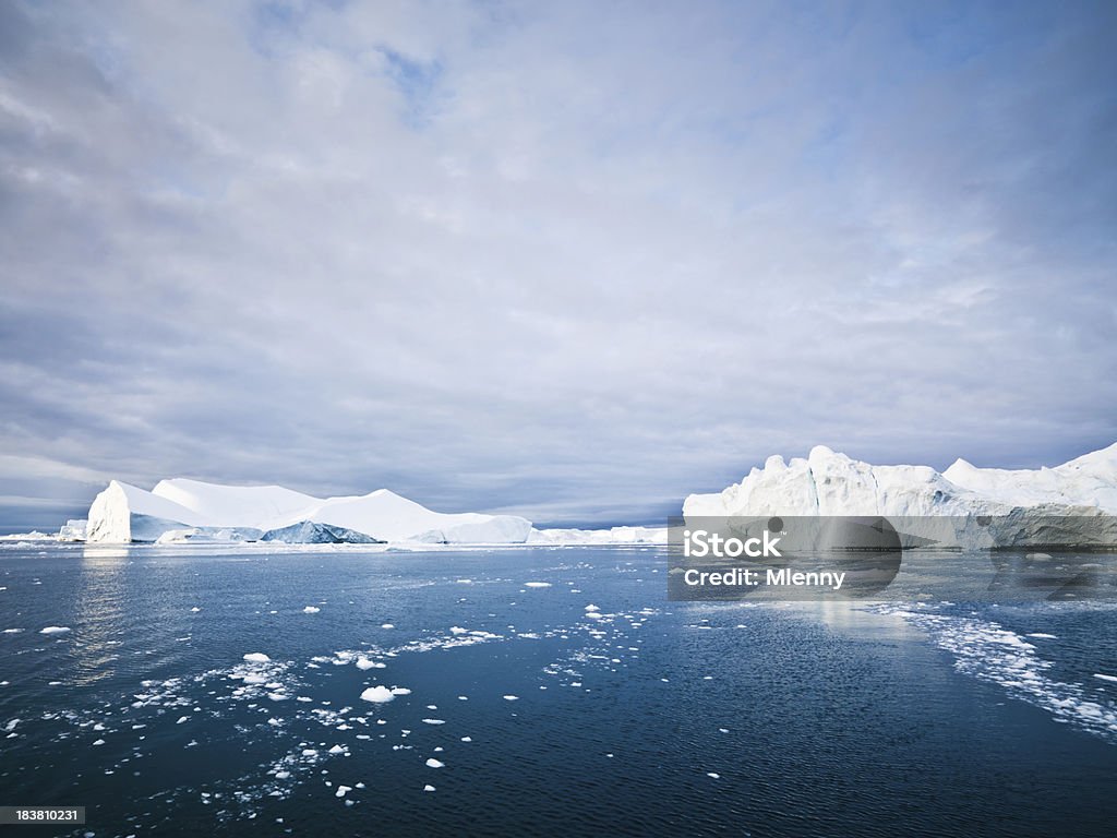 Arctic Icebergs and Ice Floes Ilulissat Fjord North Pole Seascape "Huge Icebergs drifting in polar arctic icefjord at the west greenland coast. Ilulissat Icefjord, Greenland, North West Coast. Hasselblad H4D 50Mpixel." Arctic Stock Photo