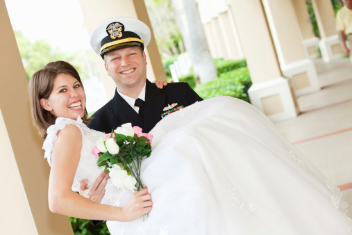 Groom in Navy Uniform Holding His New Bride.