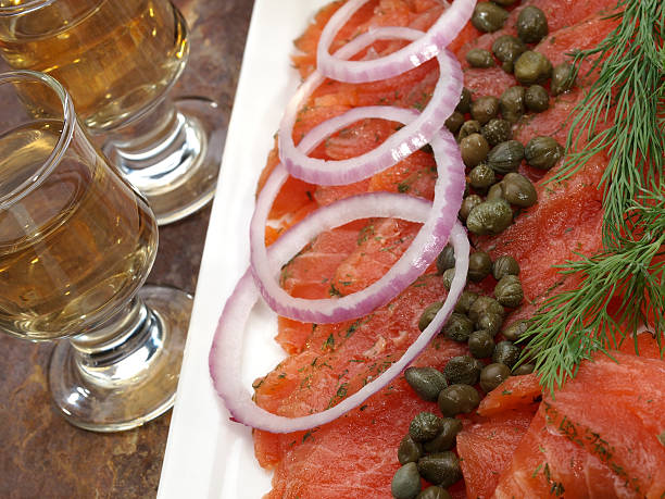Gravlax (gravad lax, gravet laks, gravlaks) "Scandinavian Salt and Sugar cured salmon platter with fresh dill, red onion and capersShot glasses" gravad stock pictures, royalty-free photos & images