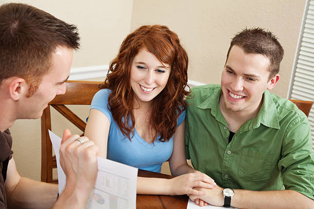 istock Young Couple Looking Holding Hands During Meeting With Counselor 183811407