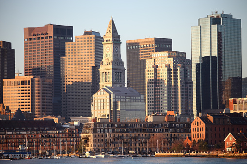 Boston skyline including the Custom House Tower as seen from across the Boston Harbor. Boston is the largest city in New England, the capital of the state of Massachusetts. Boston is known for its central role in American history,world-class educational institutions, cultural facilities, and champion sports franchises.