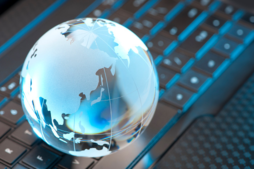 Glass Globe and Computer Keyboard with blue highlights showing Asia Pacific