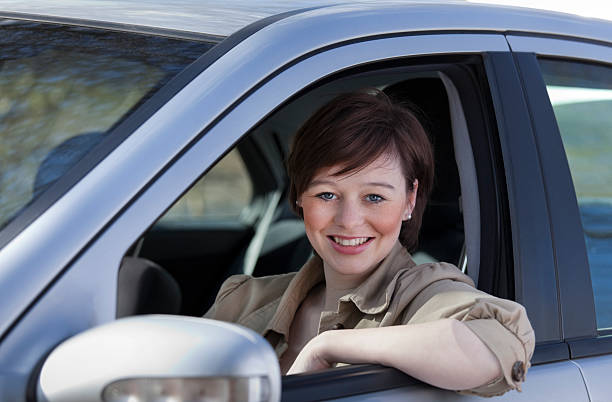 istock Smiling female sitting in her car 183812259