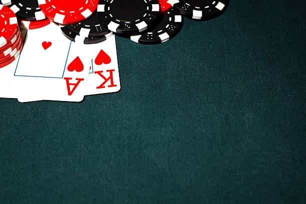 Ace King and Poker Chips Ace King of Hearts with black and red poker chips set against a green felt poker table. wsop stock pictures, royalty-free photos & images