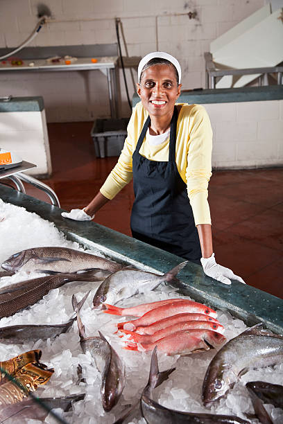 istock Worker in fish market with display of fresh catch 183812720