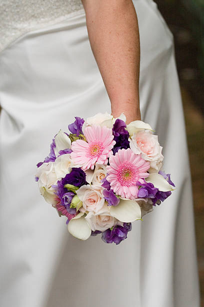 istock Bouquet with pink, white, purple, flowers being held by bride 183813606