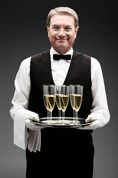 バトラーがシャンペンをお出しする - butler champagne service waiter ストックフォトと画像