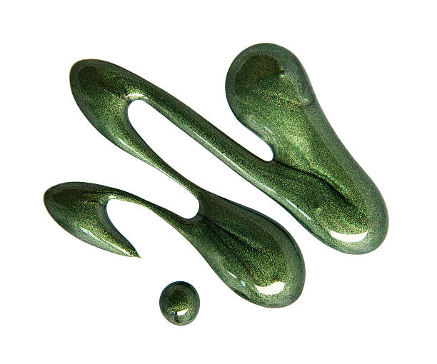 istock A squiggly pool of sparkly green nail polish 183813704