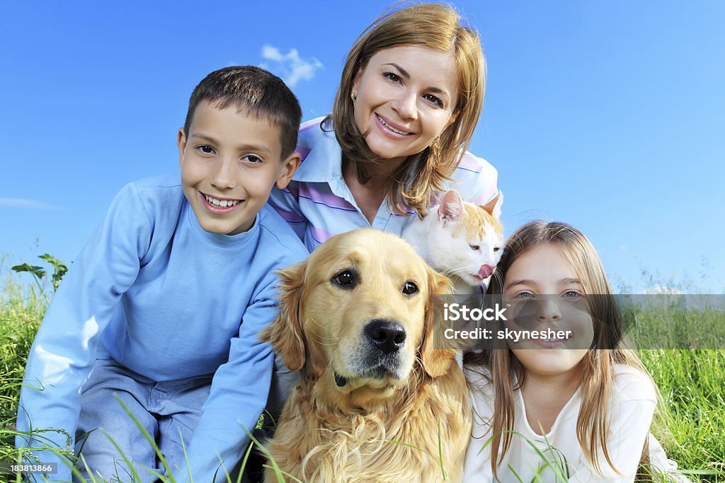 Alegre família estão desfrutando com animais ao ar livre. - Foto de stock de Cão royalty-free