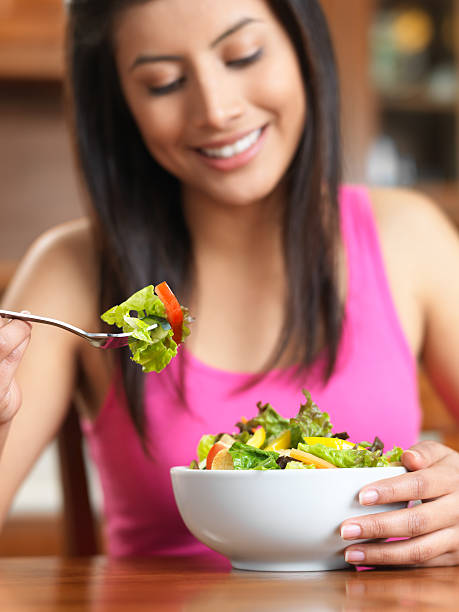 istock Healthy woman eating salad 183814436