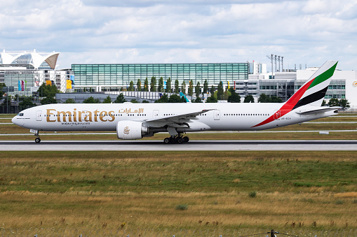 Munich / Germany - July 11, 2017: Emirates Airlines Boeing 777-300ER A6-ECV passenger plane departure and take off at Munich Airport