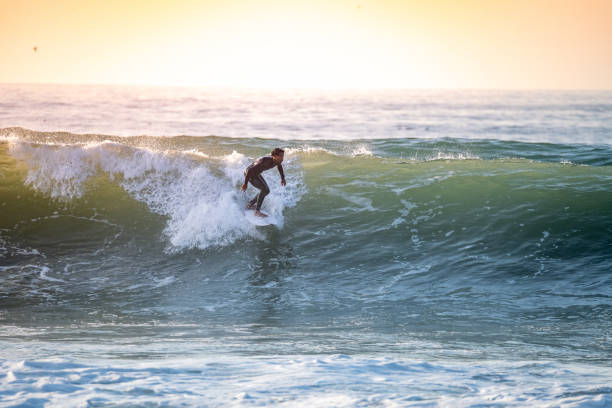 istock Sporty boy riding his surf board 1838145490