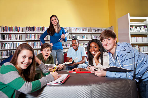 istock Group of teenage students in school library 183814597