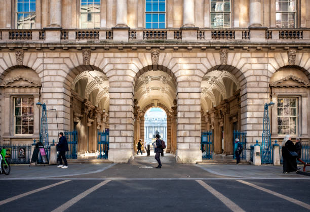 Arches at Somerset House, London A row of arches leading underneath part of Somerset House in Strand, City of Westminster, London. Several people are going about their business in the Fountain Court. university of london photos stock pictures, royalty-free photos & images