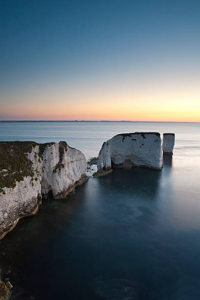 Dawn at Old Harry Rocks "A beautiful sunrise over Old Harry's Rocks, Studland Dorset" studland heath stock pictures, royalty-free photos & images