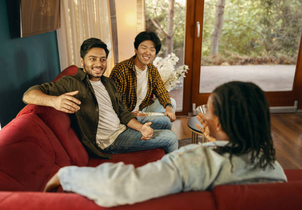 istock Cheerful young people is talking each other while having weekend home party together 1838150879