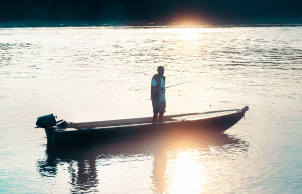 istock Young man fishing on river boat 1838153014