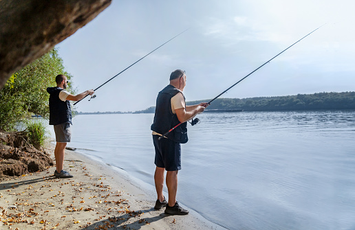 People standing and fishing in Danube river