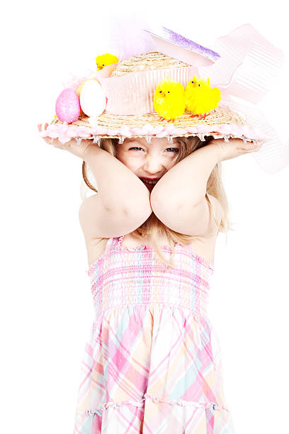 Cute 4 year old little girl wearing a homemade decorated Easter bonnet