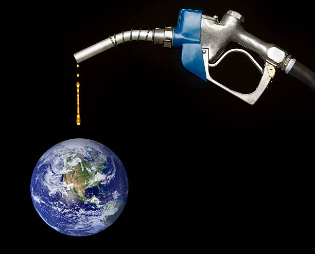 istock Gasoline Pump Nozzle Dripping on Planet Earth 183815702