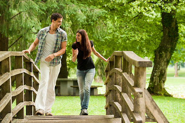 istock Young couple crossing the bridge 183815733