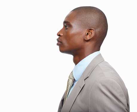 Side view of confident business man looking away on white background - copyspace