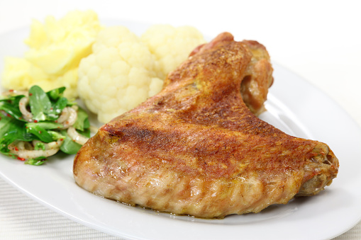 a baked Turkey Wing with Cauliflower and mash