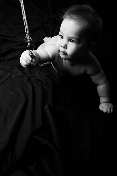 istock Curious baby boy holding mother's necklace 183816531