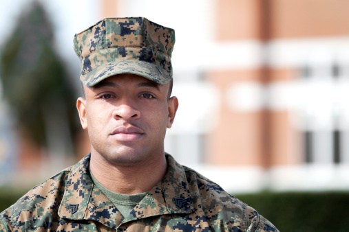 Marine sergeant standing in fron of a building.