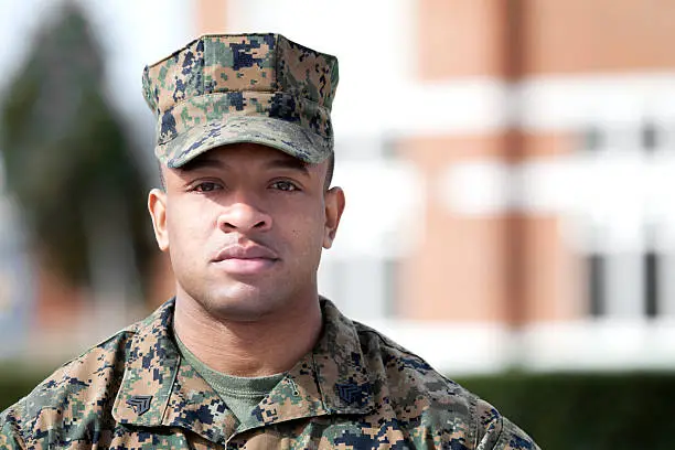 Marine sergeant standing in fron of a building.