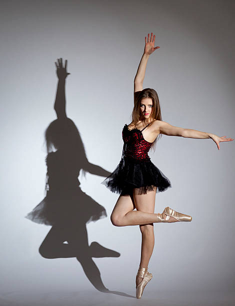 istock Young ballerina dancing on gray background 183817953